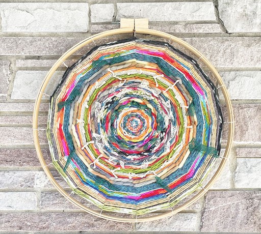 Colorful embroidery hoop loom weaving 