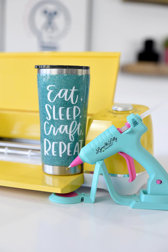 Glitter tumbler that has text design on it saying Ear, Sleep, Craft Repeat