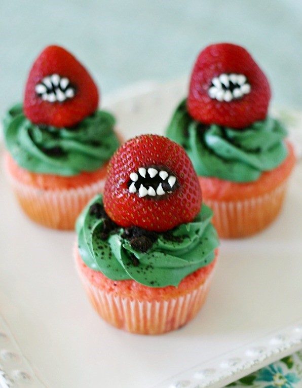 Moist strawberry cupcakes with vanilla buttercream and crushed oreo cookies with a frightening strawberry monster