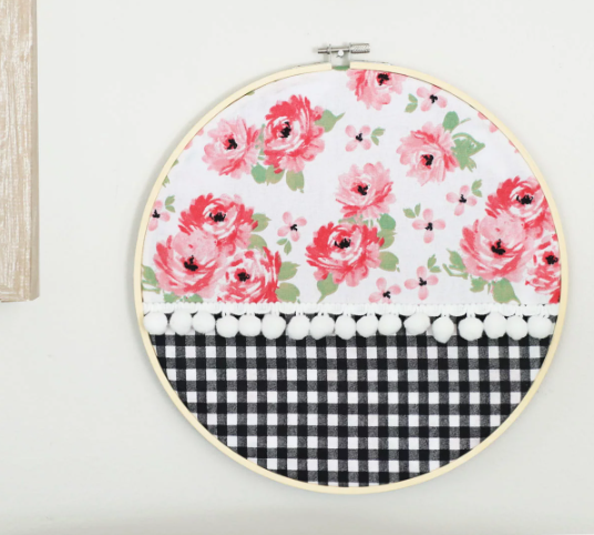 no sew embroidery hoop art that has a beautiful flowers and black and white buffalo check design and pom poms 