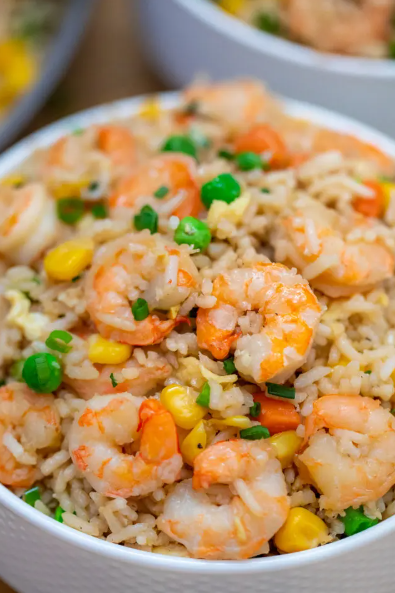 Shrimp Fried Rice made with fresh shrimp, rice, green onions, peas, carrots, and sesame oil