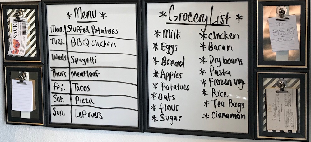 meal planning command center that has the menu, and grocery lists on it made from dollar store frames