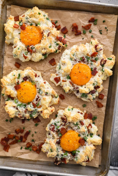 Fluffy egg whites loaded with crispy bacon bits, parmesan cheese & fresh chives with a runny yolk in the center