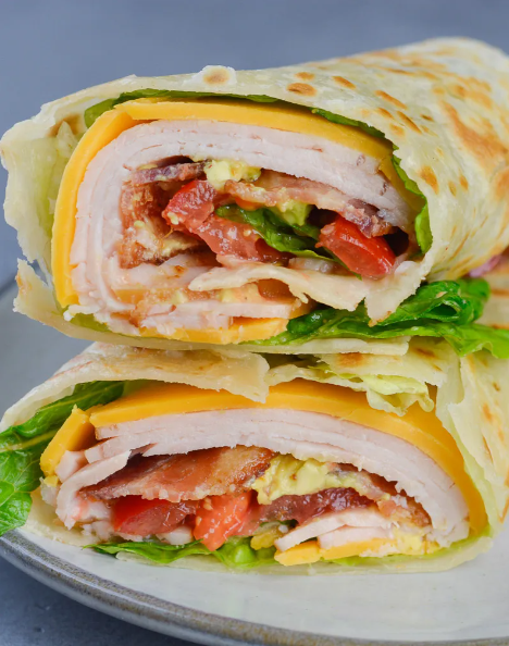 California Turkey Club Wrap packed with fresh vegetables, deli turkey, and crispy bacon