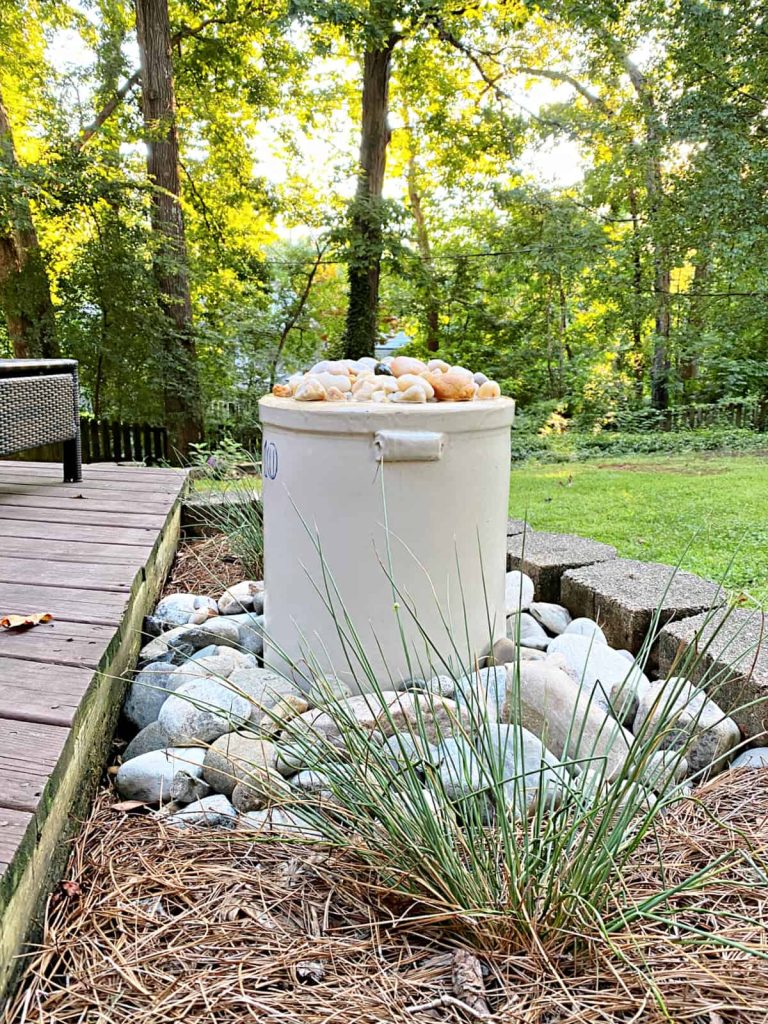 DIY water feature from an old crock for a backyard deck.