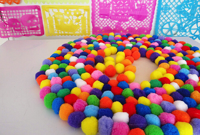 A pompom rug perfect for tee girl bedroom